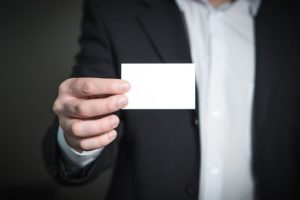 man holding biz card