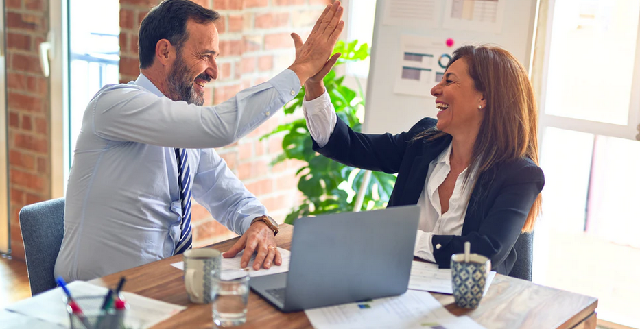 man and woman high fiving
